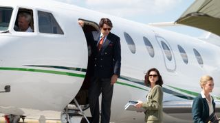 Bernard Tapie (Laurent Lafitte) steps off a plane in Class Act