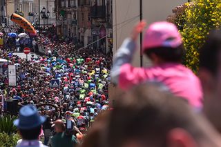 Fans wearing pink cheer on the peloton during stage 4 at the Giro d'Italia