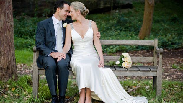 couple taking wedding photo in park