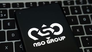 The NSO Group logo on a smartphone that's been placed on a keyboard