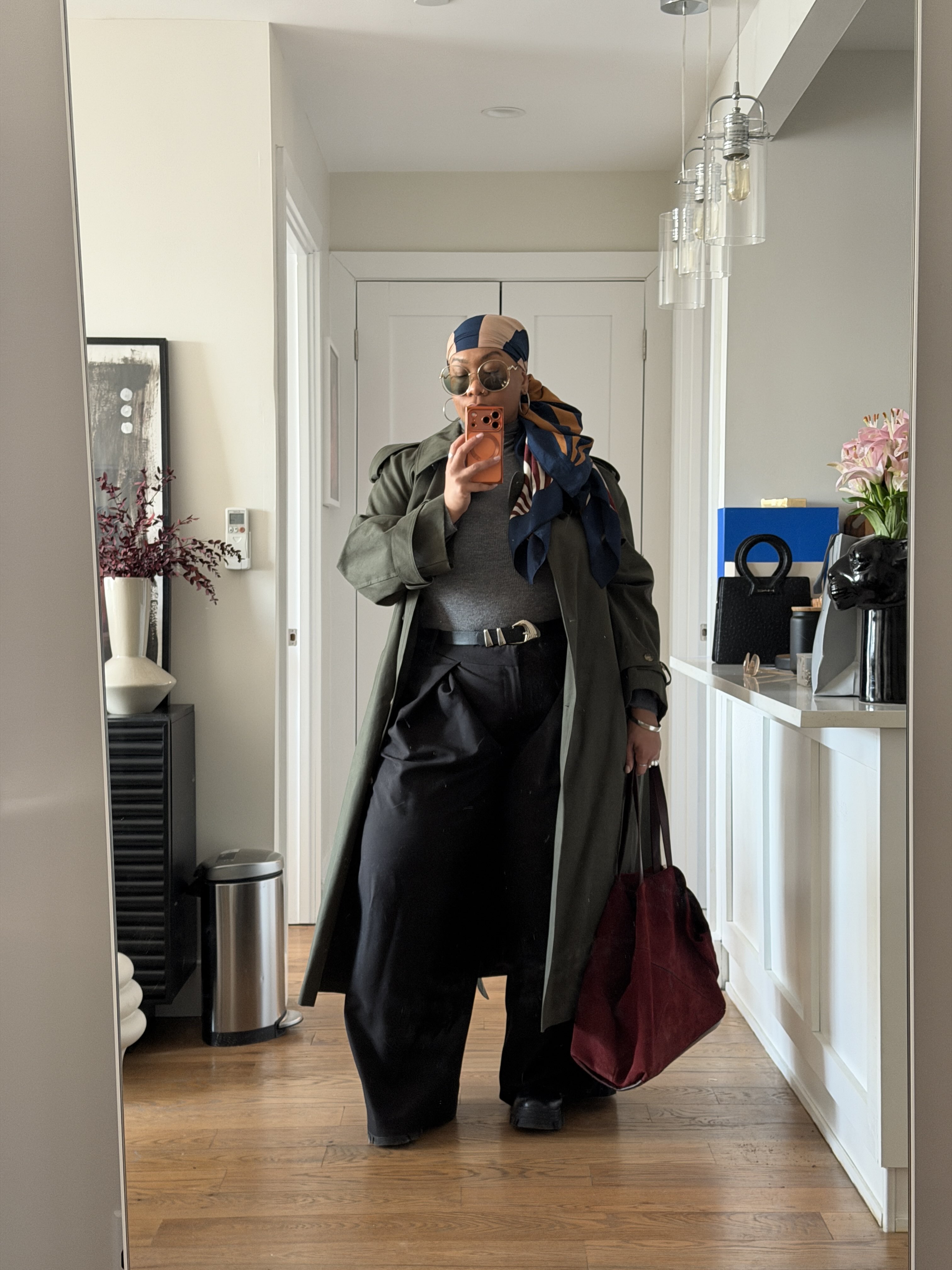 Kelly Augustine taking a selfie holding a red bag