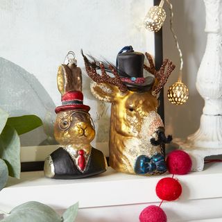 showpiece of mr. rabbit and mr. reindeer over shelf of fireplace