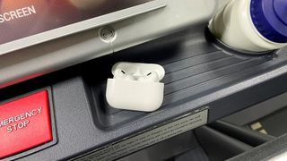 AirPods Pro 2 in charging case on a Technogym treadmill