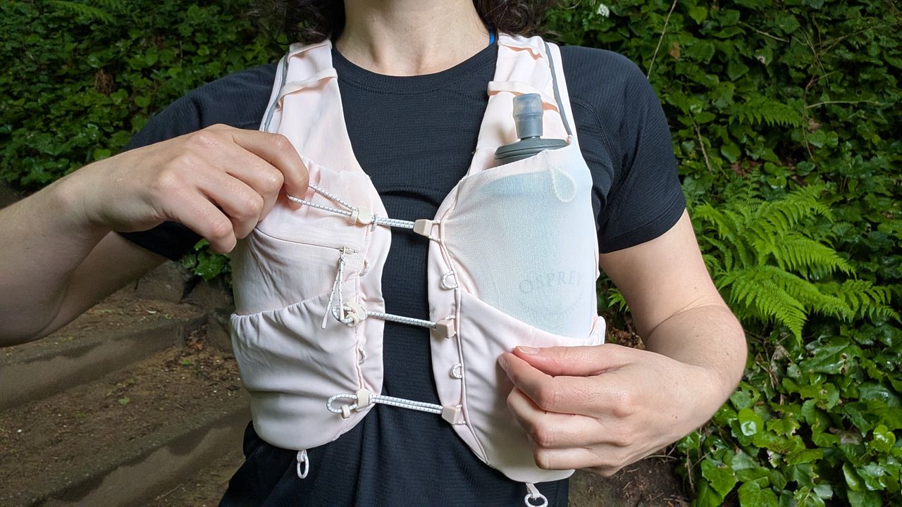 Close-up detail of bungee fastenings on a pink H&amp;M Move Lightweight Running vest