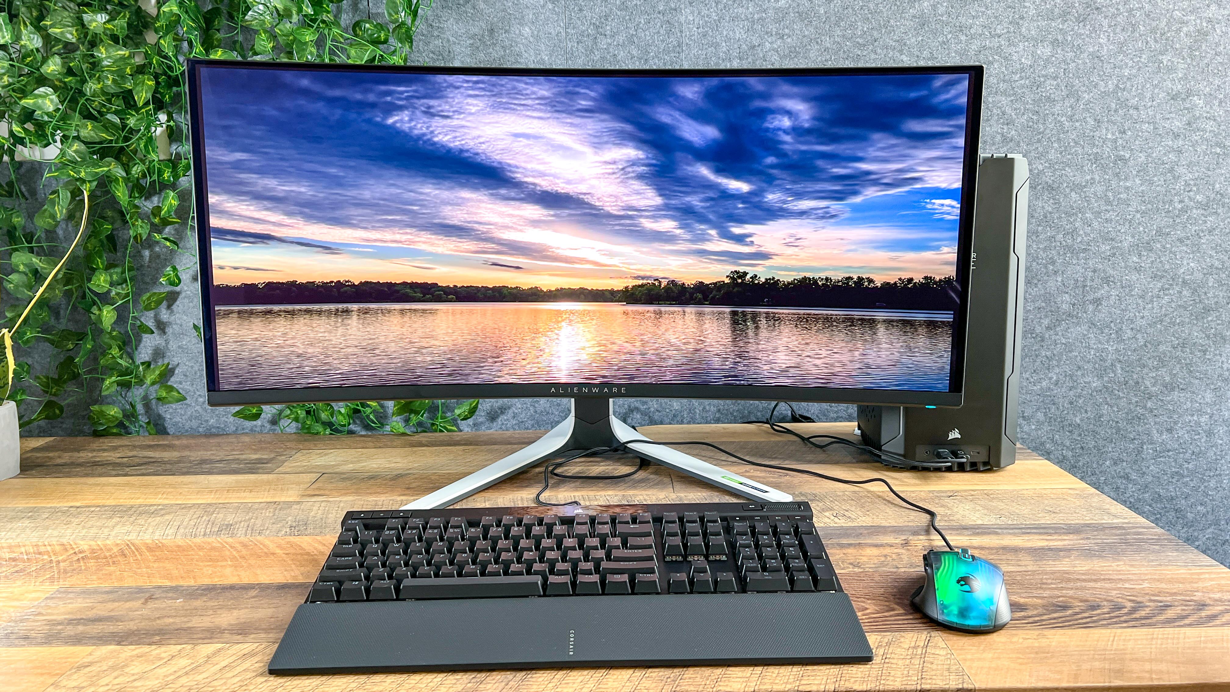 Alienware 34 Curved QD-OLED gaming monitor on a desk showing desktop