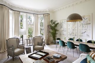 neutral dining room and living space, elegant furniture, teal dining chairs, drapes
