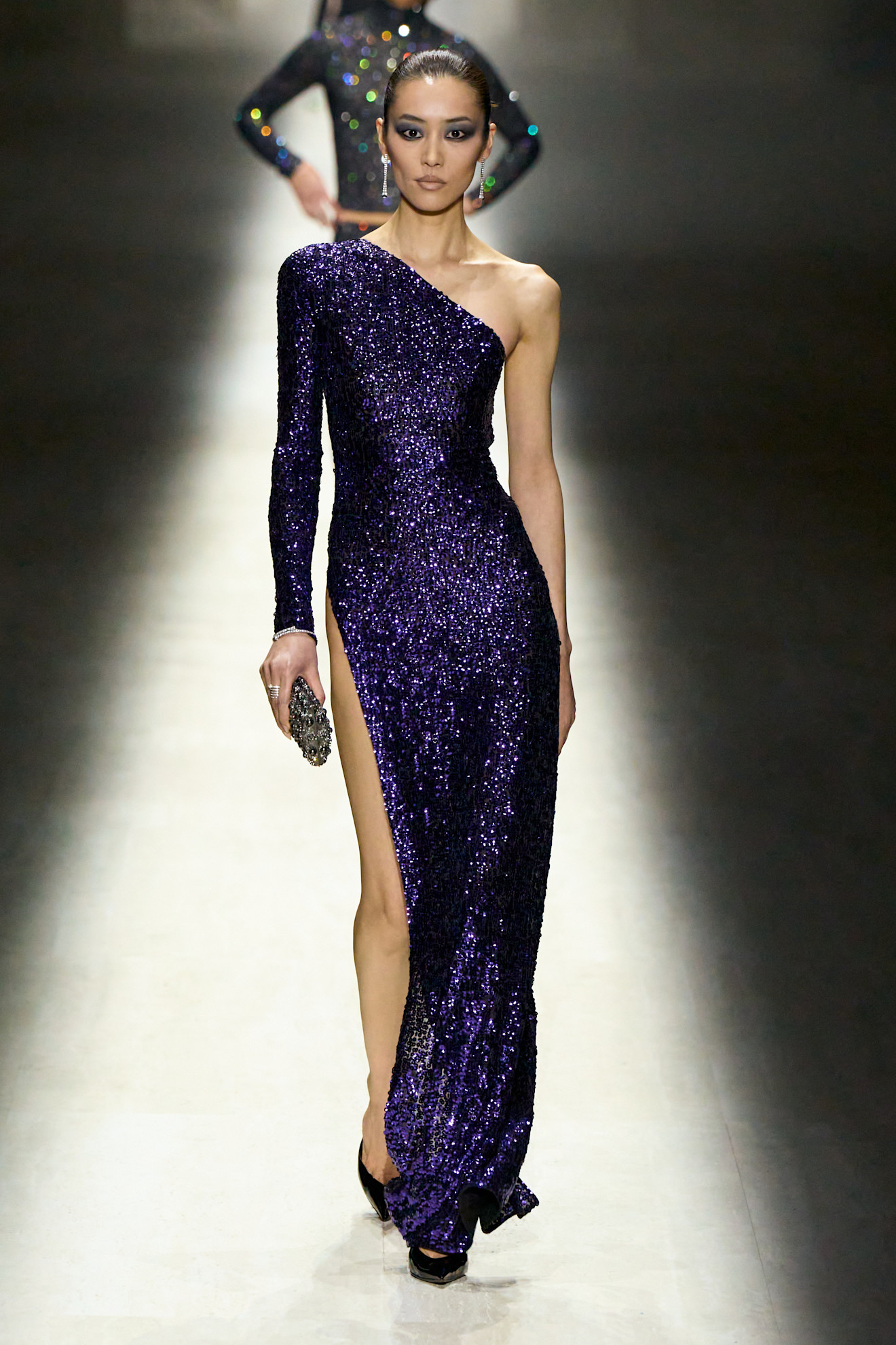 Model wears dark purple on the AW26 runway.