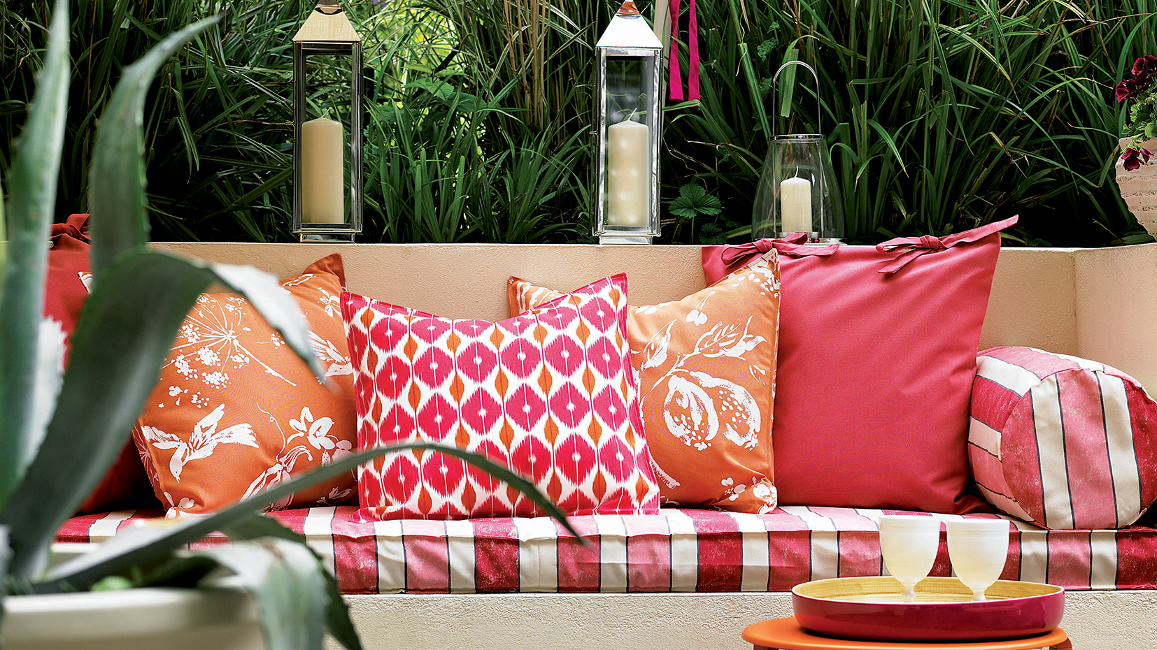 Terrace seating with red and orange cushions red and white striped fabric