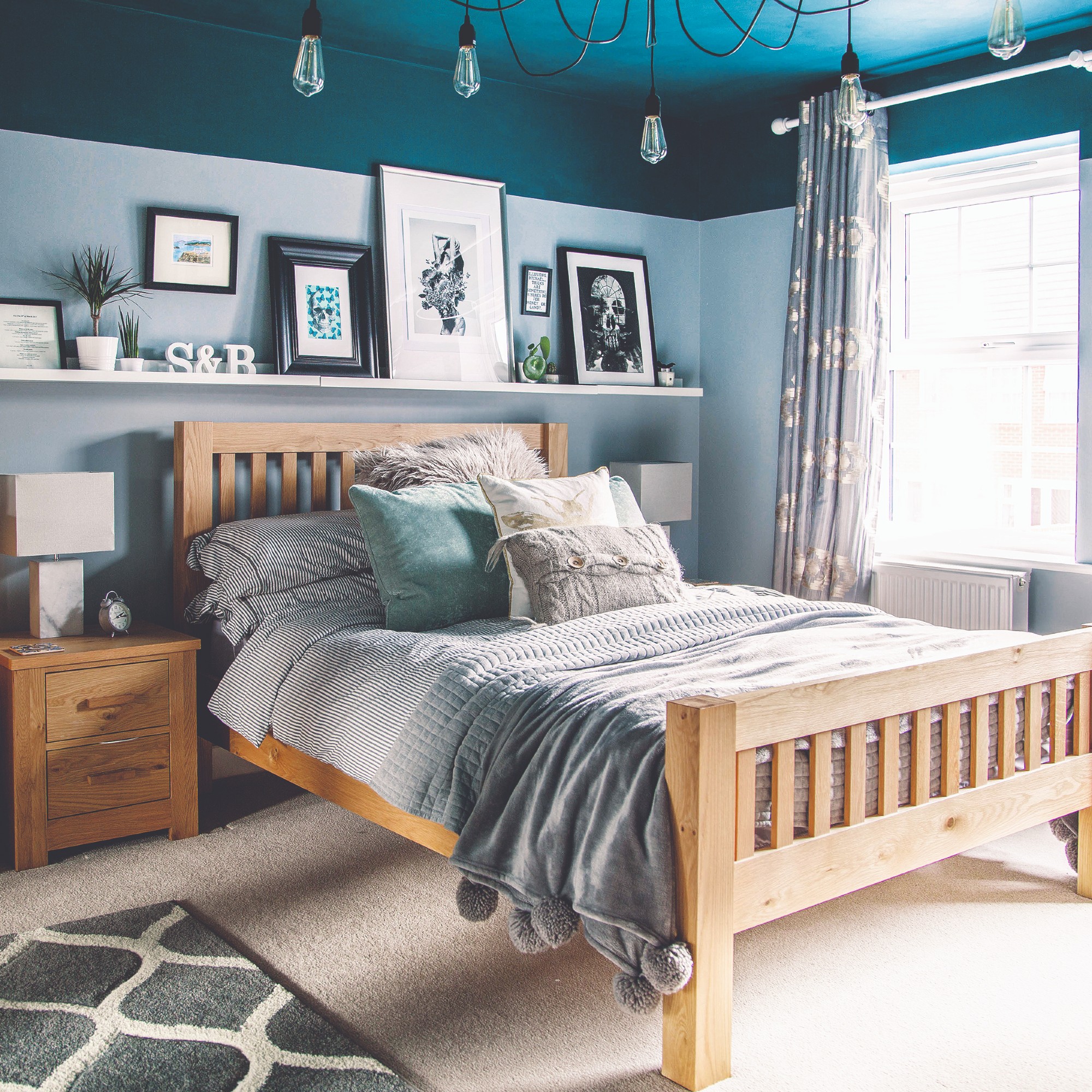 A blue bedroom with a darker shade of ceiling and spider ceilings lights