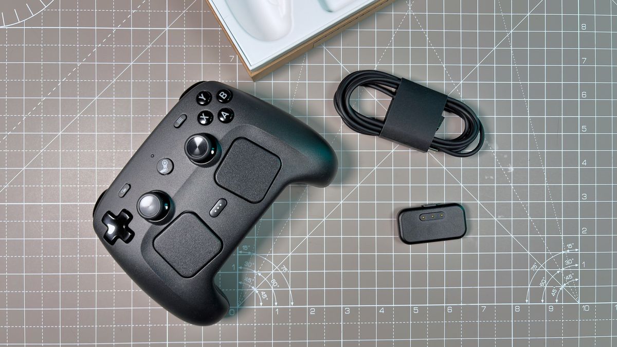 The Steam Controller on a desk during a teardown, with various parts removed.