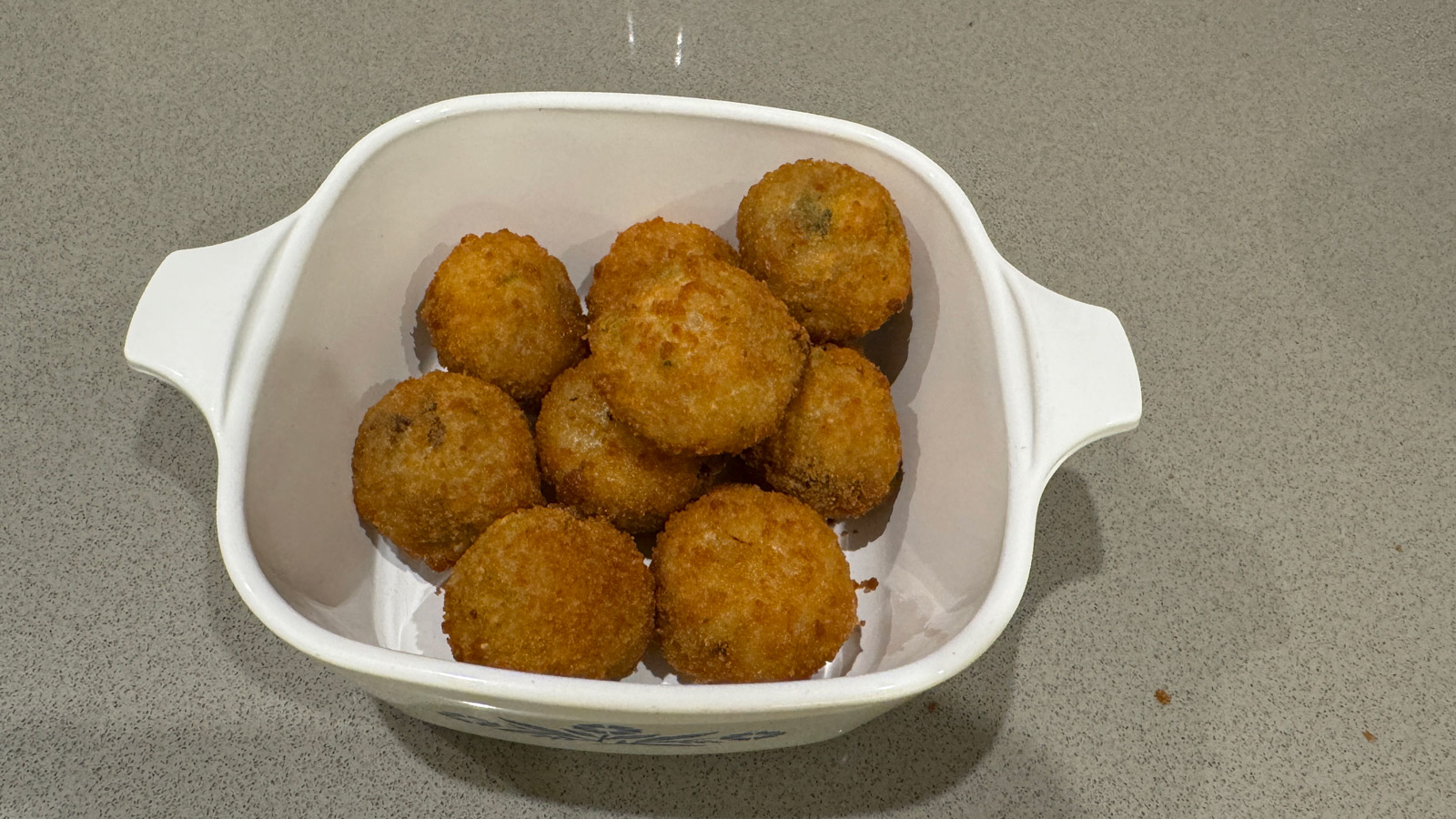 Cooked arancini balls in a bowl