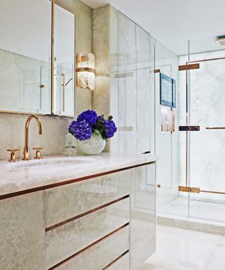 bathroom with onyx vanity unit, rose gold taps and shower enclosure