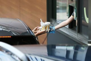A person takes their food at a Drive Thru McDonald's on June 04, 2020 in Stourbridge, England.