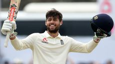 England’s Ben Foakes raises his bat after scoring a century on his Test debut in Sri Lanka