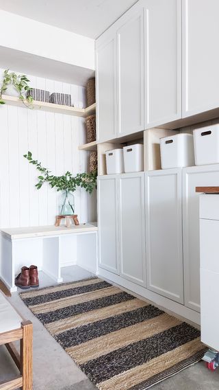 A white painted storage unit in the mudroom