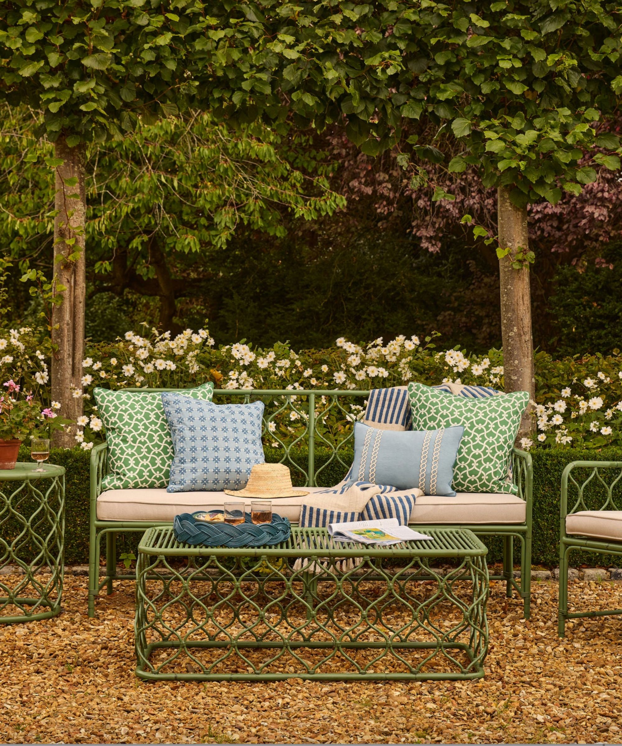 Green metal outdoor furniture with green and blue patterned cushions