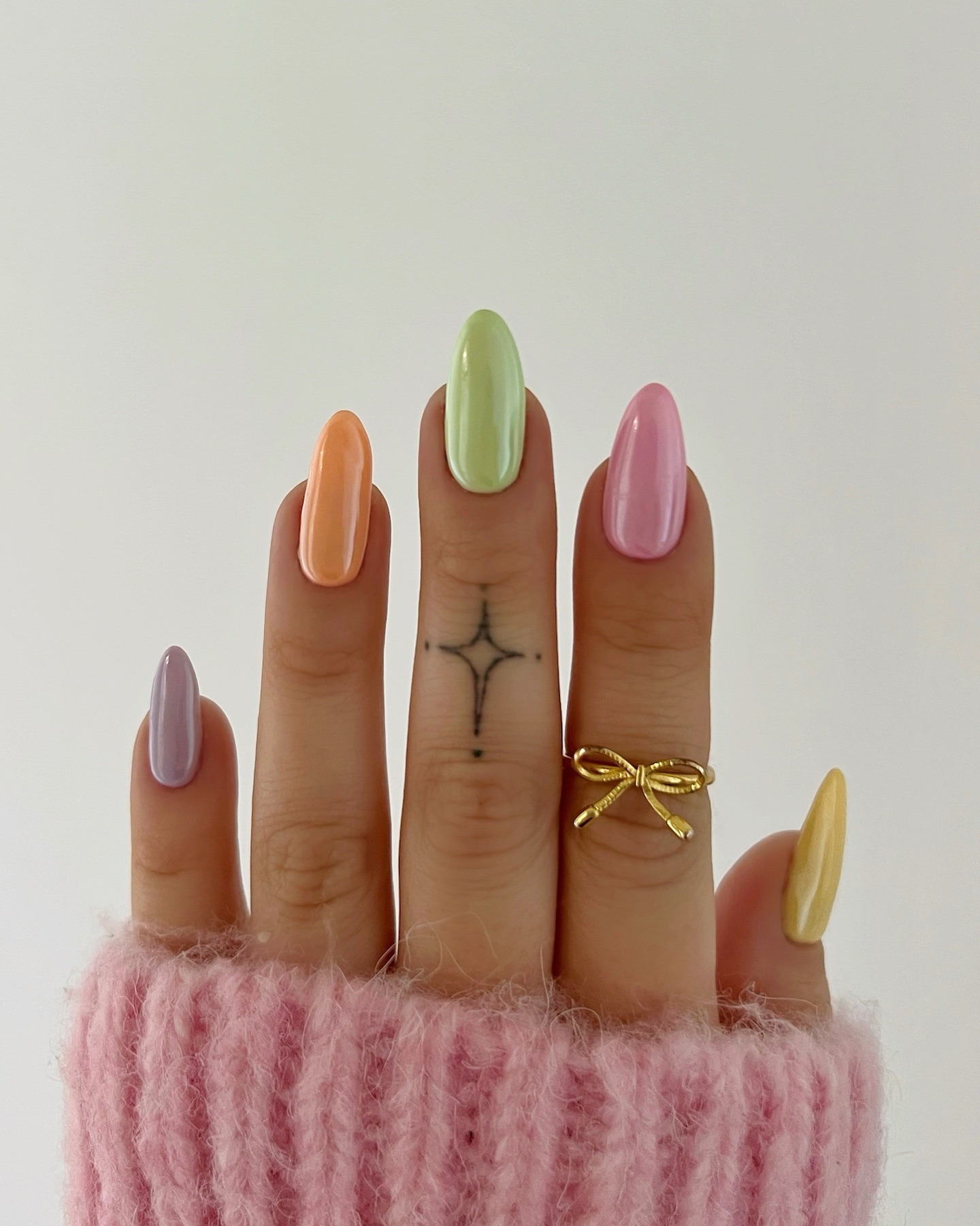 Multicolored pastel nails with a chrome finish.