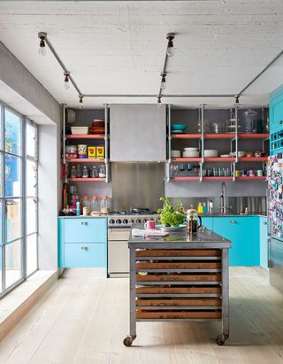Colorful blue kitchen with industrial style kitchen island idea