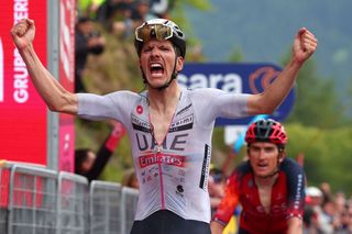 TOPSHOT UAE Team Emiratess Portuguese rider Joao Almeida celebrates as he crosses the finish line to win the sixteenth stage of the Giro dItalia 2023 cycling race 203 km between Sabbio Chiese and Monte Bondone near Cavedine on May 23 2023 Photo by Luca Bettini AFP Photo by LUCA BETTINIAFP via Getty Images