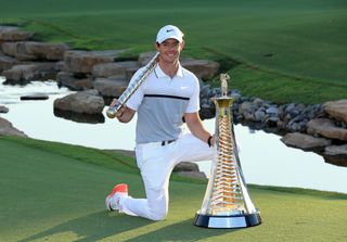 Rory McIlroy poses with the race to dubai trophy