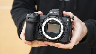 Nikon Z6 III camera in the hand with no lens attached and full-frame sensor on display