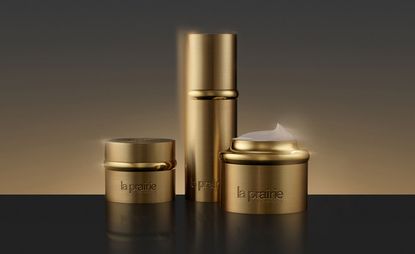Still life image of La Prairie gold collection bottles 