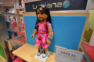 American Girl's new Luciana Vega, as seen for sale at the company's Houston store, comes with a nebula-patterned dress and iridescent shoes. An accessories set adds a shiny holographic backpack, astronaut ice cream and a smart watch for Luciana to wear.