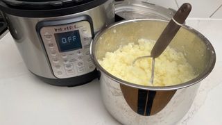 Potatoes that have been steamed and mashed in the bowl of an Instant Pot