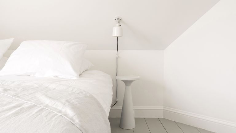 White bedroom with minimalist sheets and paint scheme