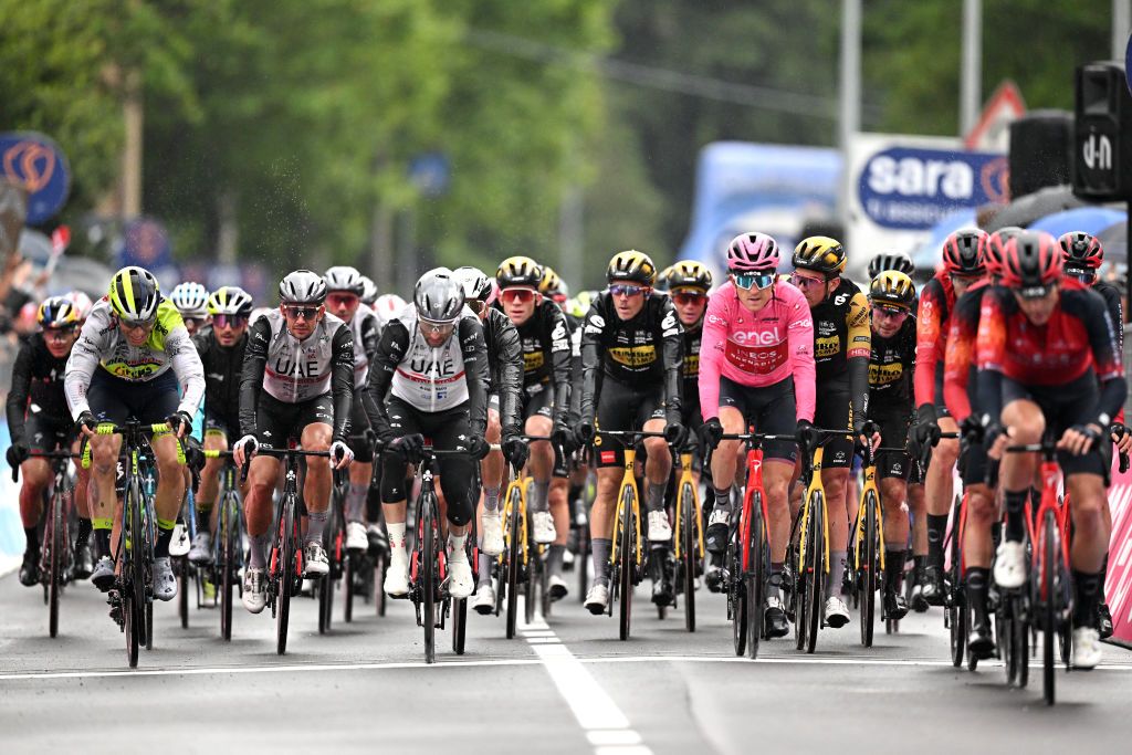 CASSANO MAGNAGO ITALY MAY 20 LR Diego Ulissi of Italy and UAE Team Emirates Geraint Thomas of The United Kingdom and Team INEOS Grenadiers Pink Leader Jersey and the peloton cross the finish line during the 106th Giro dItalia 2023 Stage 14 a 194km stage from Sierre to Cassano Magnago UCIWT on May 20 2023 in Cassano Magnago Italy Photo by Stuart FranklinGetty Images