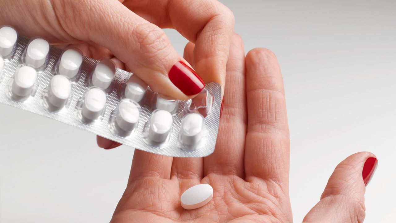 Pill being removed from packet