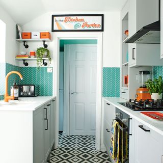 kitchen with white cabinet white walls and white marble countertop with microwave