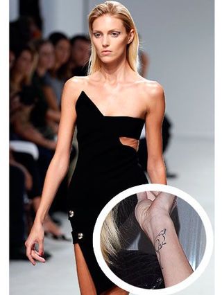 Anja Ruibik wearing black dress on catwalk, insert showing wrist tattoo