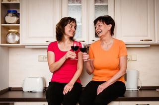 mother and daughter drinking wine