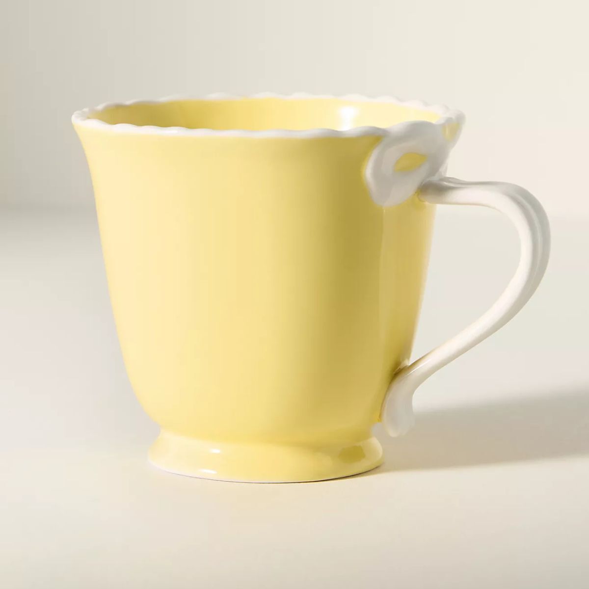 Yellow mug with bow detailing on the handle