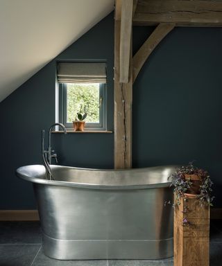 blue bathroom with stainless steel bath