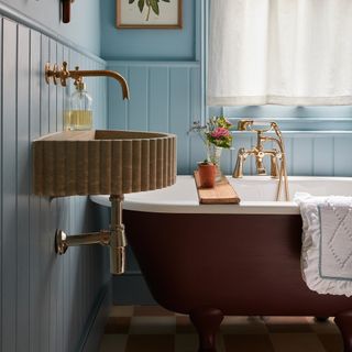 Bathroom with blue wall panelling and red bath
