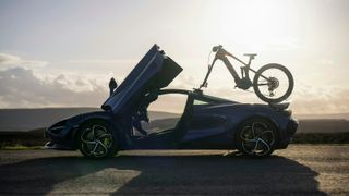 McLaren e-MTB mounted to the top of a McLaren sports car