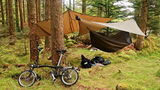 tarp stretched over camping equipment