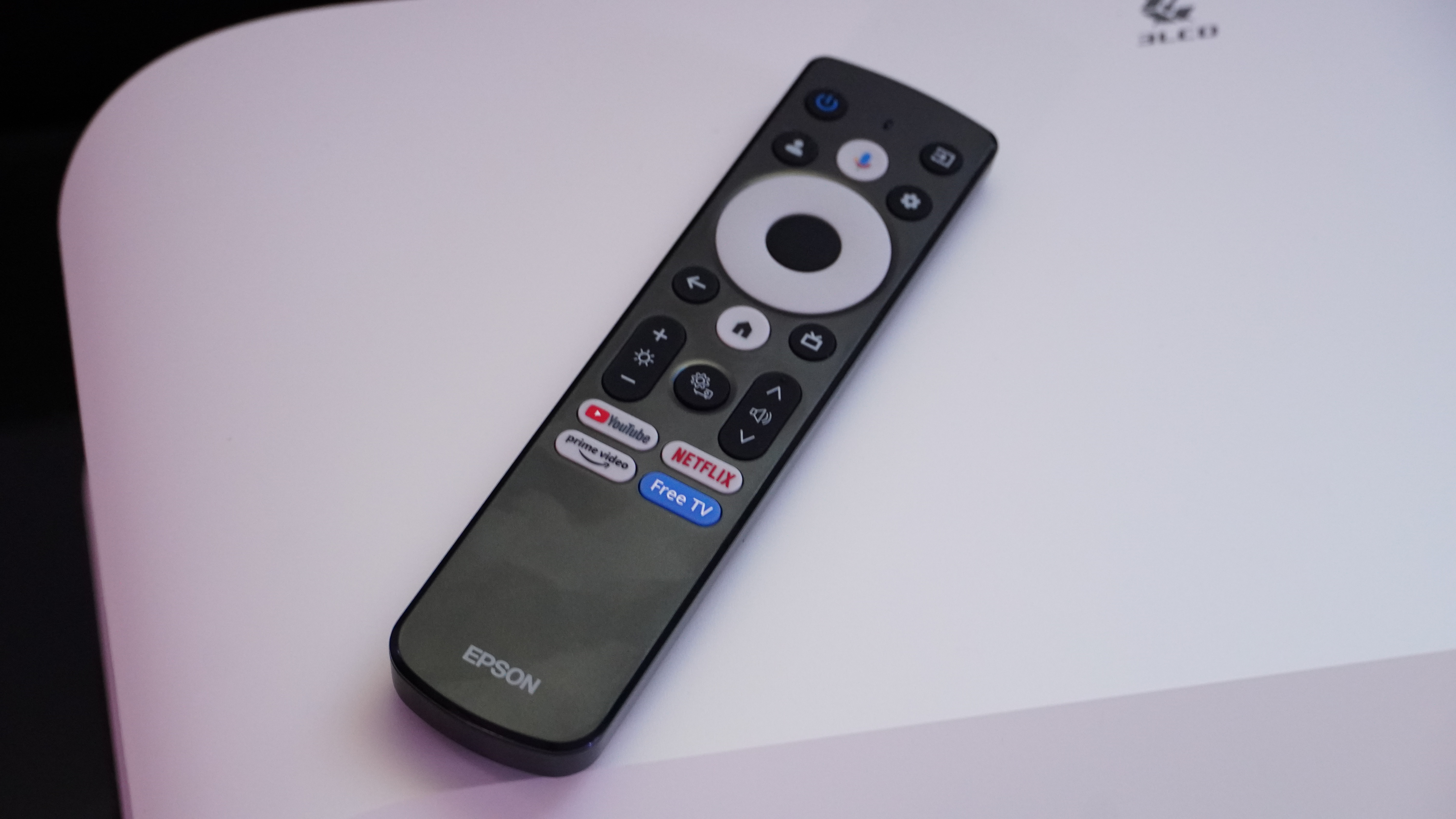 The Epson LifeStudio Grand Projector's remote on a white surface