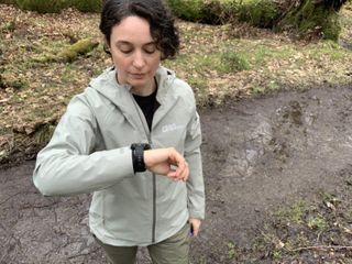 A hiker looking at her Garmin Fenix 8 watch