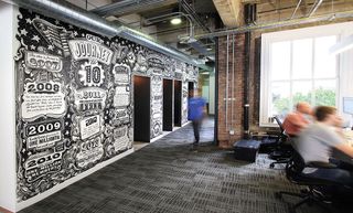 Credit Karma's office wall is covered in a cool black and white timeline mural