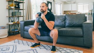 Man holding a kettlebell in goblet style