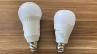 The Eufy Lumos bulb (left) and Kasa Smart bulb (right)