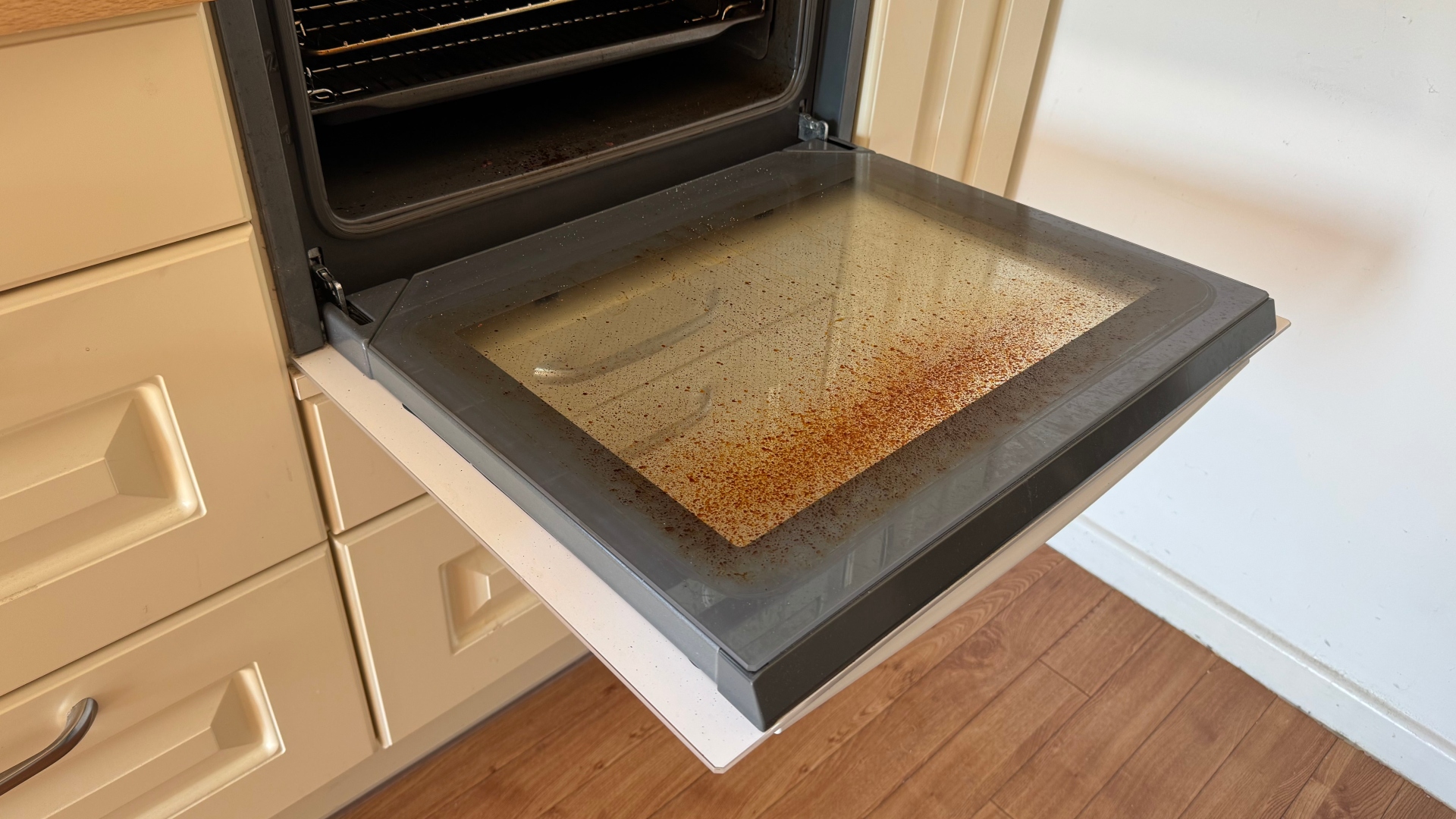 An oven door before cleaning