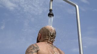 Man taking an outdoor shower