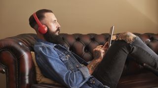 Best budget wireless headphones: Man listening to music