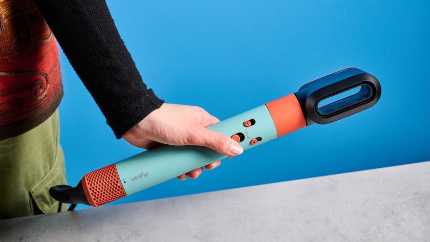 the dyson airwrap ID in teal and terracotta colorway (patina and orange) with a lapis case, with a brush, hairfryer, curling wand attachments