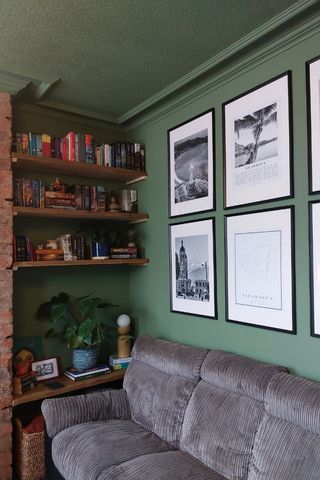 green living room with black and white artwork and alcove shelving