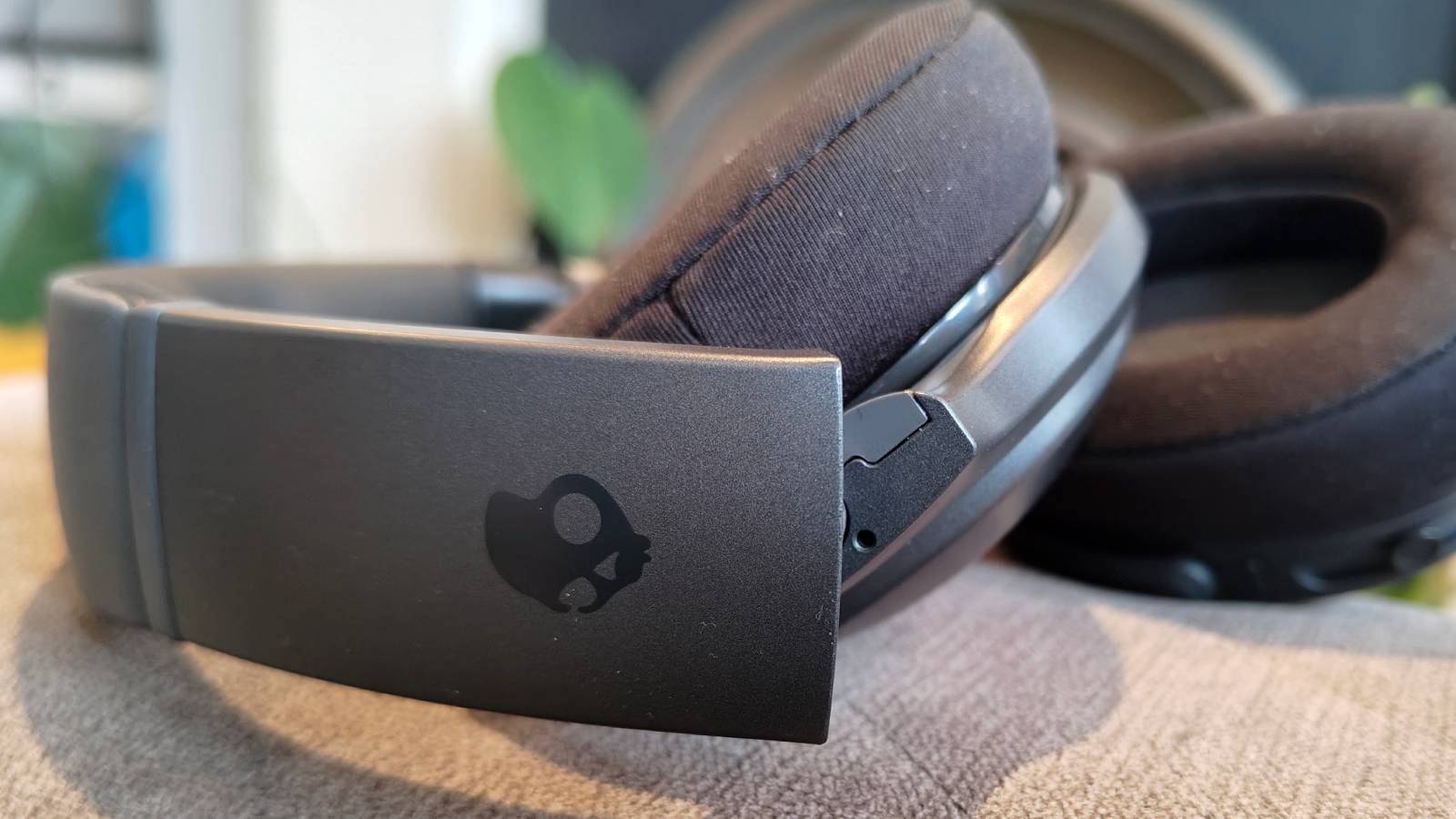 The Skullcandy Crusher 540 Active on a sofa.